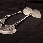 Photo d'une paire de boucles d'oreilles posée sur un fond noir